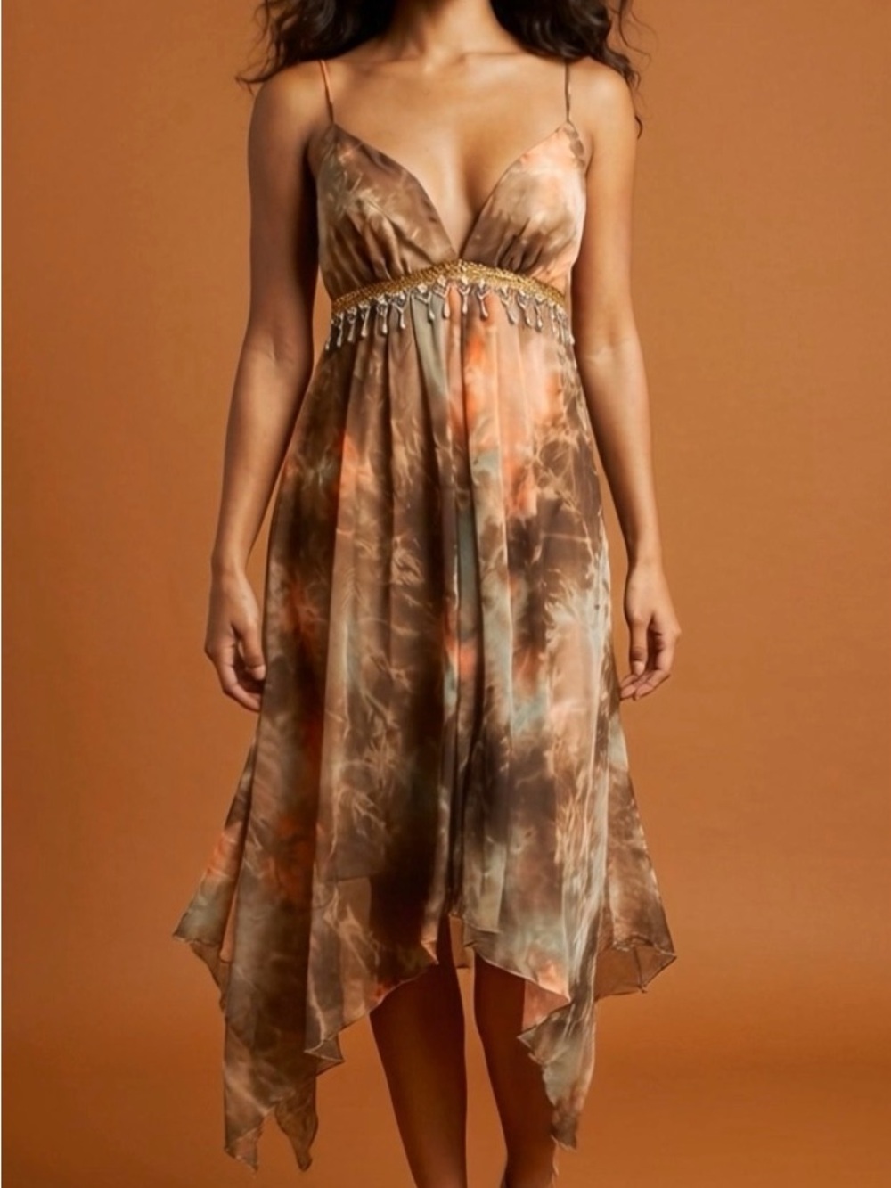 This ABS dress features a handkerchief hem beaded waist vibrant abstract colors